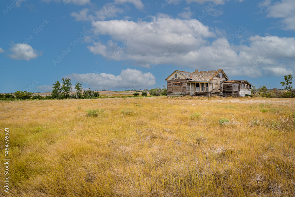 Abandoned home in a farmyard on the prairies near Rush Lake, SK Abandoned home in a farmyard on the prairies near Rush Lake, SK