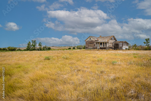 Abandoned home in a farmyard on the prairies near Rush Lake, SK