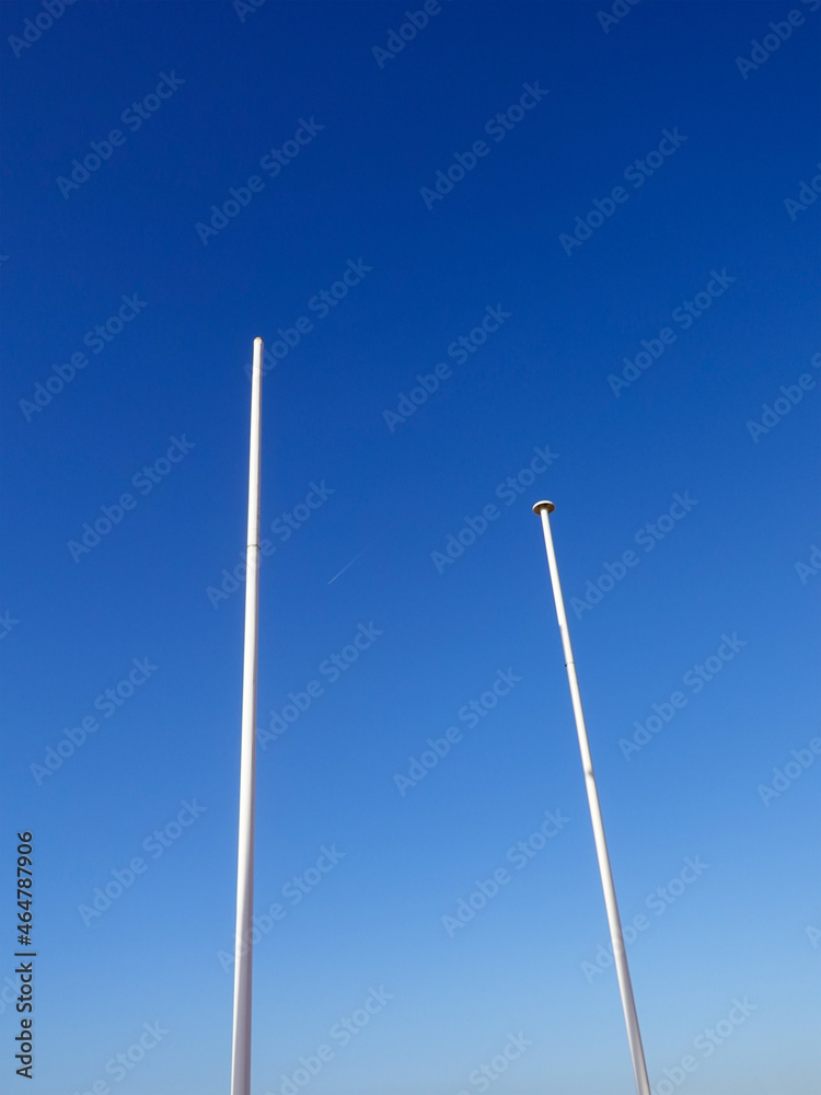 Two white masts in the blue sky of Saint Cyr Les Lecques. Two white masts in the blue sky of Saint Cyr Les Lecques.