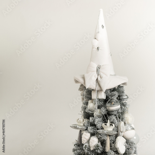 Isolated top of gray-white Christmas tree on white background 