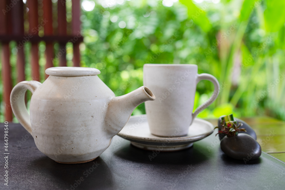 Fototapeta premium hot tea was poured into tea cup served on table in cafe