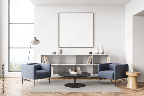 Square frame with two blue armchairs in white living room © ImageFlow