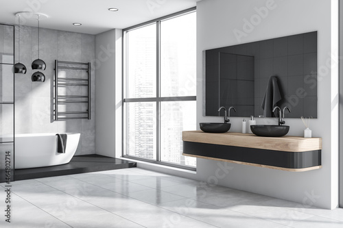 Modern light grey and white bathroom with accent dark details. Corner view.