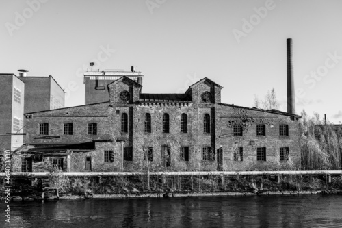 Old paper factory buliding by a river photo