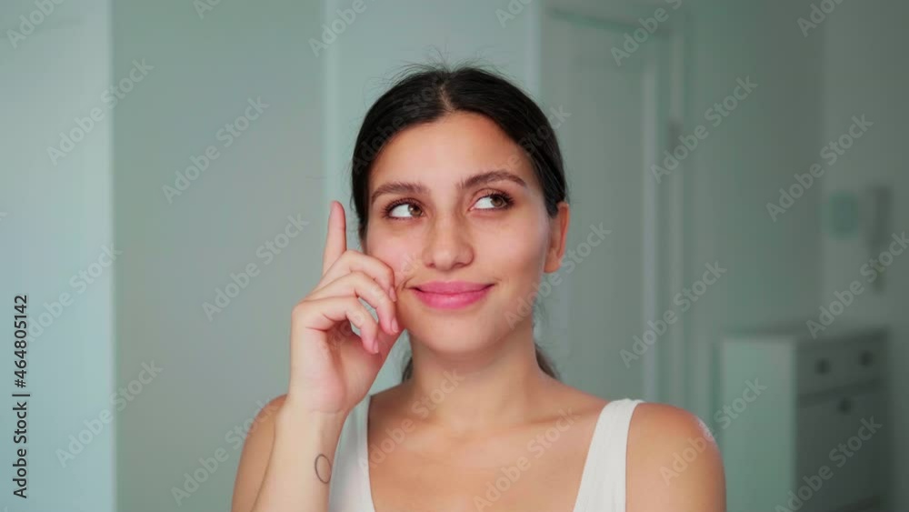 Female portrait. A young girl is thinking about a new idea and smiling for the camera. Medium shot, white background. High quality 4k footage.Hand near face Female portrait. A young girl is thinking about a new idea and smiling for the camera. Medium shot, white background. High quality 4k footage.Hand near face