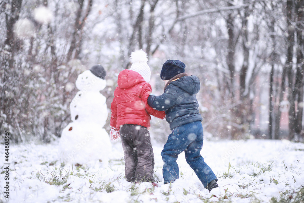 Kids walk in the park first snow