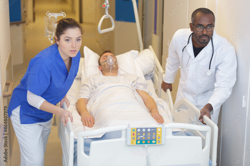 patient hospital bed moved by medical staff to operating room Stock ...