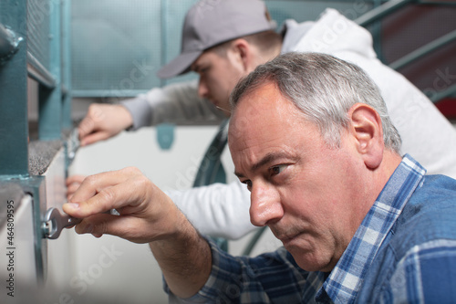 plumber with apprentice learning the trade