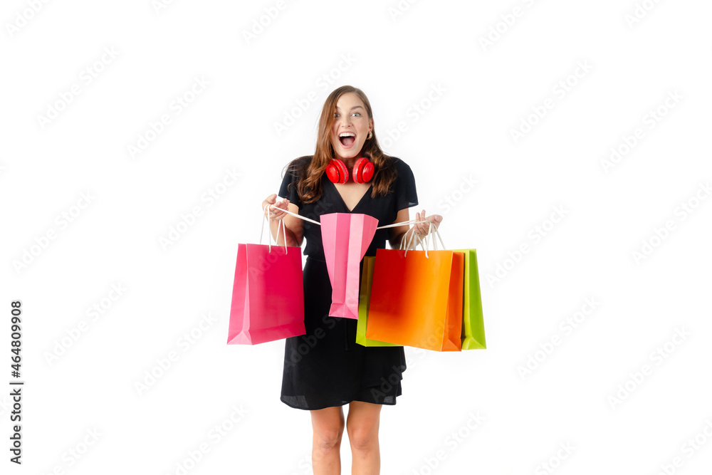 Sale. cheerful beautiful young caucasian woman in black dress holding shopping bags isolated on white background, lifestyle, smart communication technology, online shopping and payment online concept