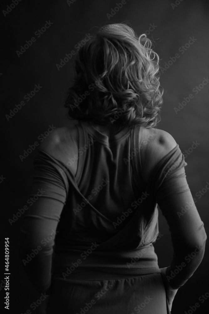 black and white photo shoot, dramatic full-length portrait of a woman, human movements on camera, unfocused and noisy portrait on an old film camera