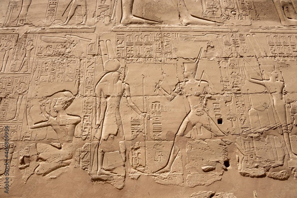 Naklejka premium Ancient Egyptian murals and writings on the stone walls of the Karnak Temple in Luxor