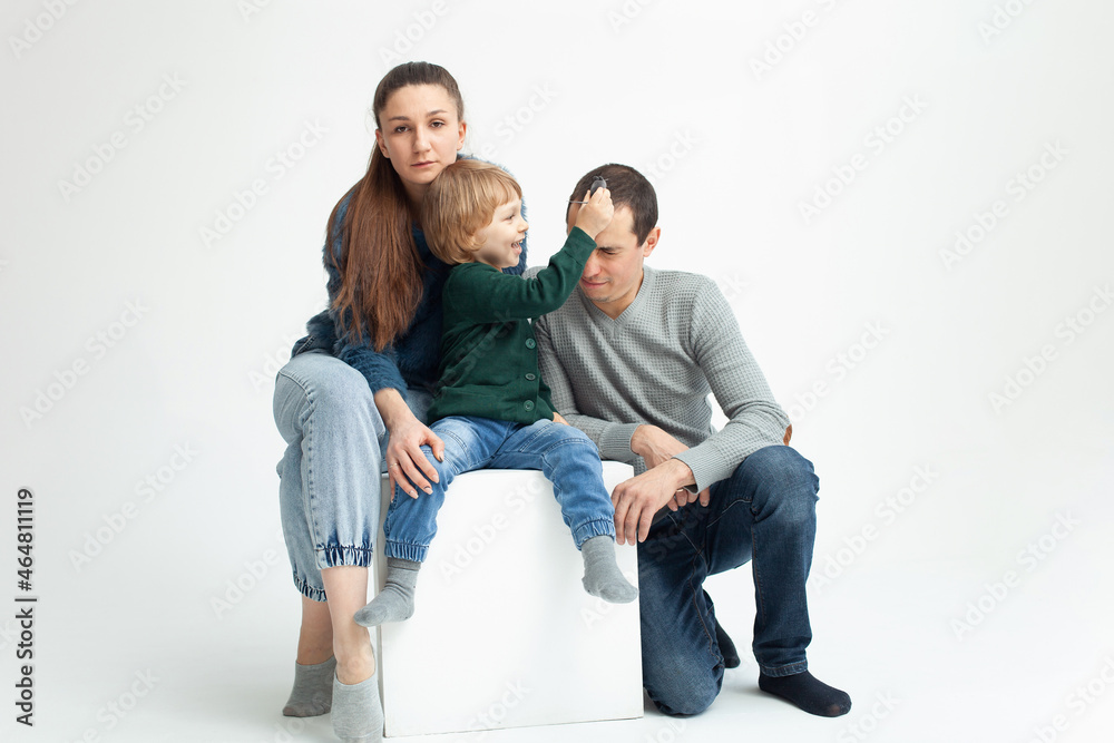 Problems in family, divorce, child is naughty, shkodly. family on white background isolated. Concept. child indulges, does not want to obey, pranks, mom and dad tired, sad, angry. Problems in family, divorce, child is naughty, shkodly. family on white background isolated. Concept. child indulges, does not want to obey, pranks, mom and dad tired, sad, angry.