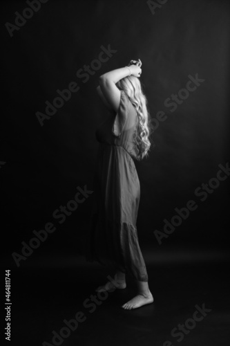 black and white photo shoot, dramatic full-length portrait of a woman, human movements on camera, unfocused and noisy portrait on an old film camera