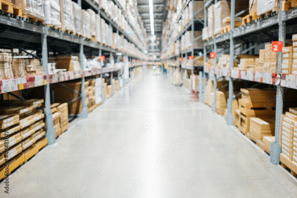 Large hangar warehouse of logistics companies. Warehousing on the floor and called the high shelves. Toning the image. Large hangar warehouse of logistics companies. Warehousing on the floor and called the high shelves. Toning the image.