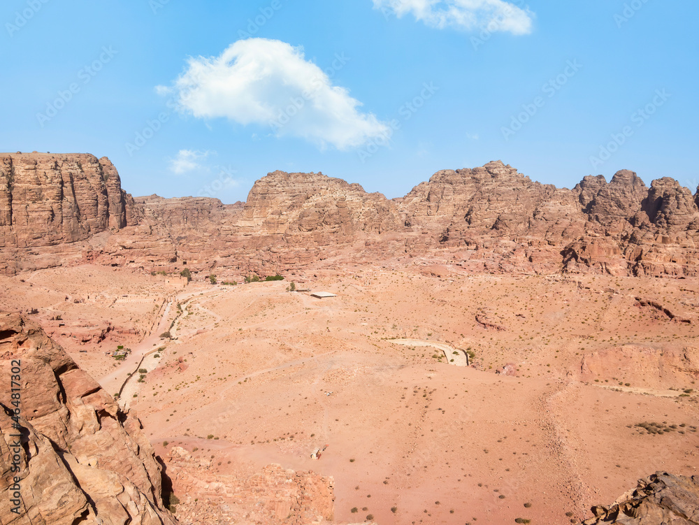 Aerial scene from the ancient city of Petra, Jordan. View of the Colonnaded Street and a massive rock red mountain in the background