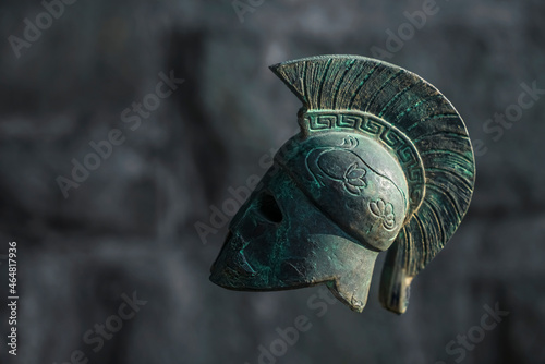Historical Replica Spartan Warrior Helmet on astone wall background photo