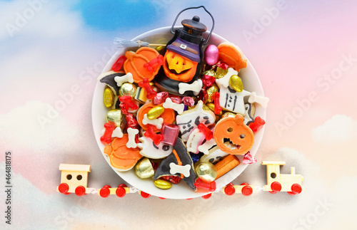 holiday Halloween candy bowl of cookies, candy, chocolates and sweets, Halloween Jack o Lantern - Trick or Treat Halloween card dark background