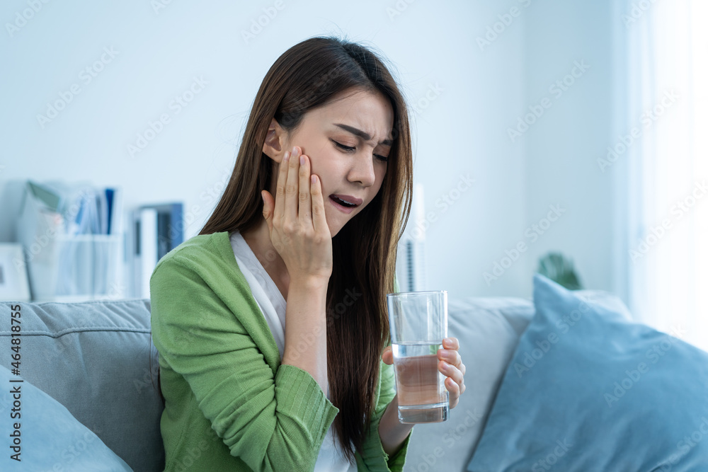 Asian beautiful woman feel terrible toothache after drink cold water. Asian beautiful woman feel terrible toothache after drink cold water.