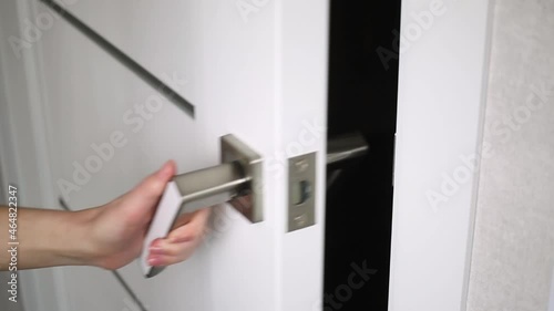 Woman hand opened door and go away in dark room, looped footage