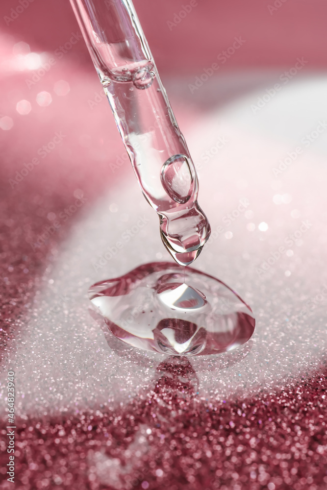 Cosmetic pipette with a pink on dark background. Cosmetic pipette with a pink on dark background.