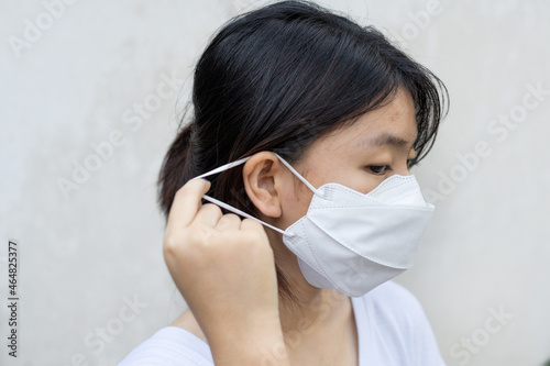 portrait Asian girl wear medical kf94  mask properly on white background. close up isolated photo