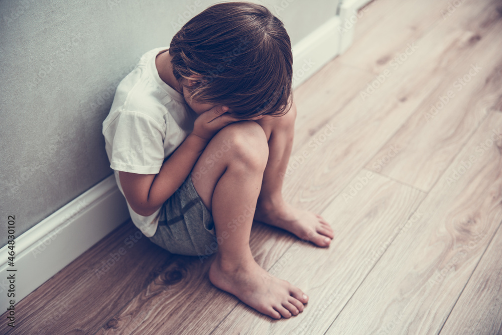 Boy crying covered his face with his hands. Stressed child. Domestic Family violence and aggression concept violence. Concept for bullying, depression stress or frustration Boy crying covered his face with his hands. Stressed child. Domestic Family violence and aggression concept violence. Concept for bullying, depression stress or frustration