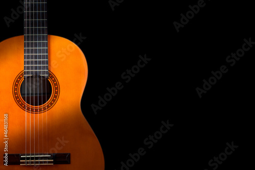 Classical guitar on black background. Acoustic guitar concept.Perfect for flyer, card, poster or wallpaper