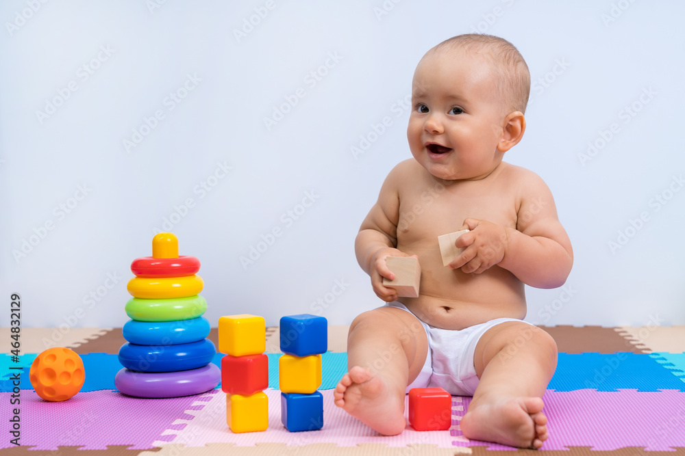 Portrait of happy laughing baby 8-12 months old in playroom on white background Portrait of happy laughing baby 8-12 months old in playroom on white background
