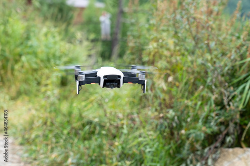 A modern drone flies in the mountains. quadcopter on the background of a mountain landscape, Altai, Siberia. View of the beautiful landscape in Altai, tourism in Russia.