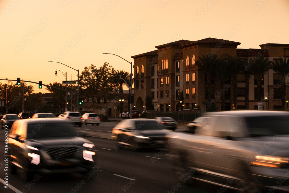 Sunset view of cars passing through the urban core of downtown Rancho Cucamonga, California, USA.