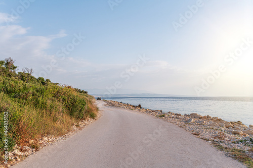 Country road on the seashore in the rays of sunset. Croatia