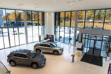 stylish modern car showroom, dealer office with new cars inside, blur photo for background