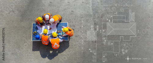 Top view of architectural engineer working on his blueprints with documents on construction site. meeting, discussing,designing, planing, roof plan