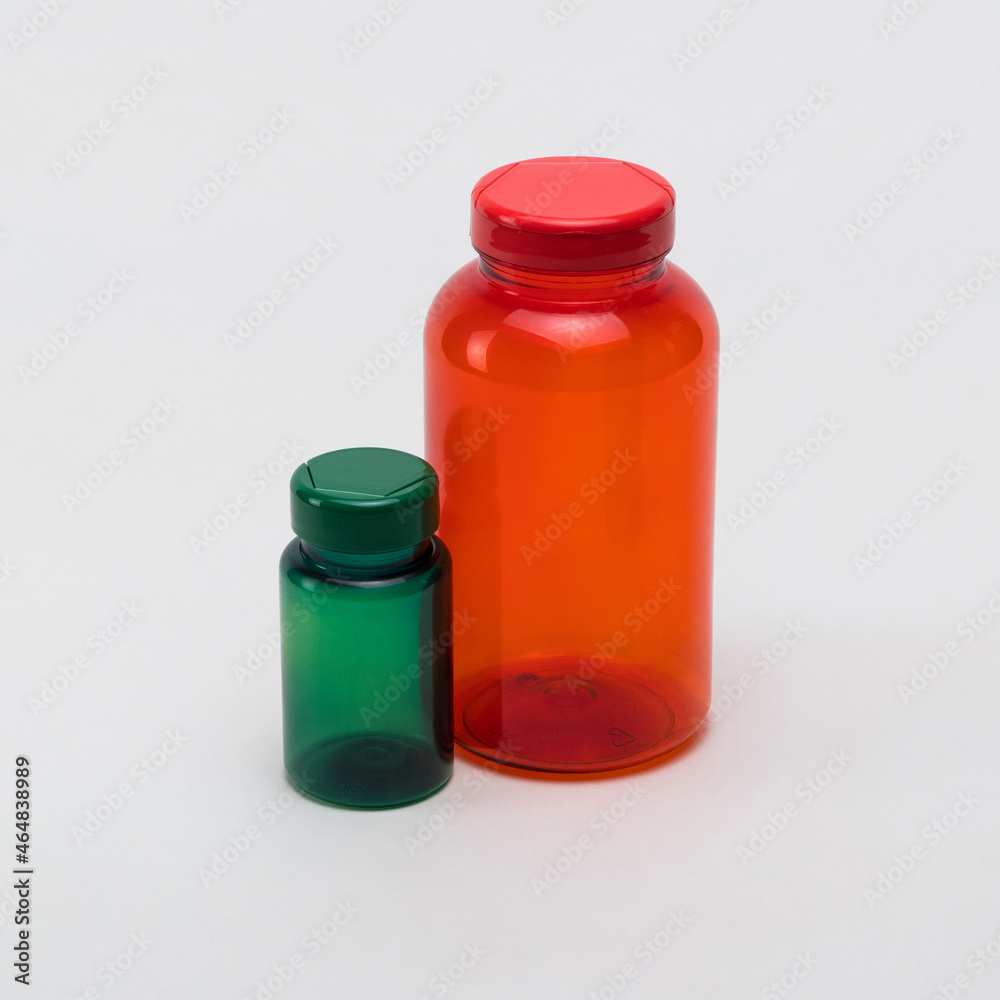 Multi colored transparent plastic pill jars on a white background. Isolated Multi colored transparent plastic pill jars on a white background. Isolated