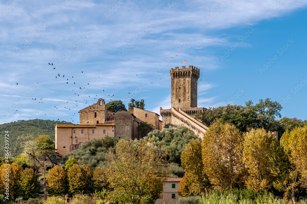 A flock of birds on the beautiful medieval fortress of Vicopisano, Pisa, Tuscany, Italy, on an autumn day of sun