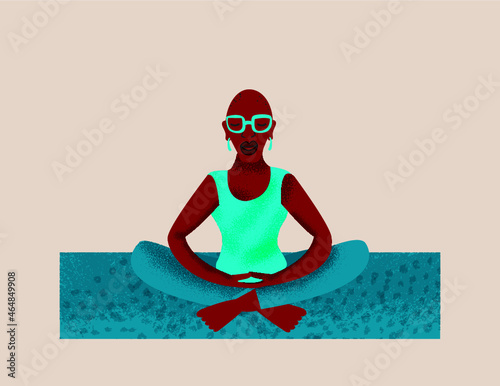 Older lesbian woman mediating on a yoga mat 