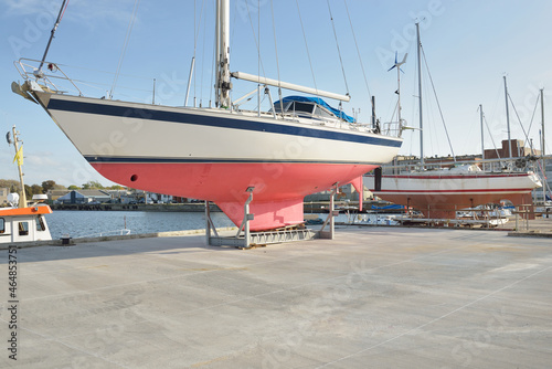 45 ft cruising sailboat standing on land in a yacht marina. Transportation, nautical vessel, repair and service, sailing, sport, recreation. tourism, leisure activity concepts photo