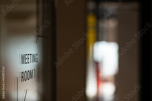 Open glass door in the company with the inscription MEETING ROOM 1, close up