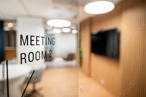 Open glass door in the company with the inscription MEETING ROOM 2, close up