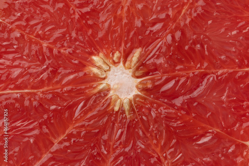 Fruit flesh of red grapefruit close up full frame as background 