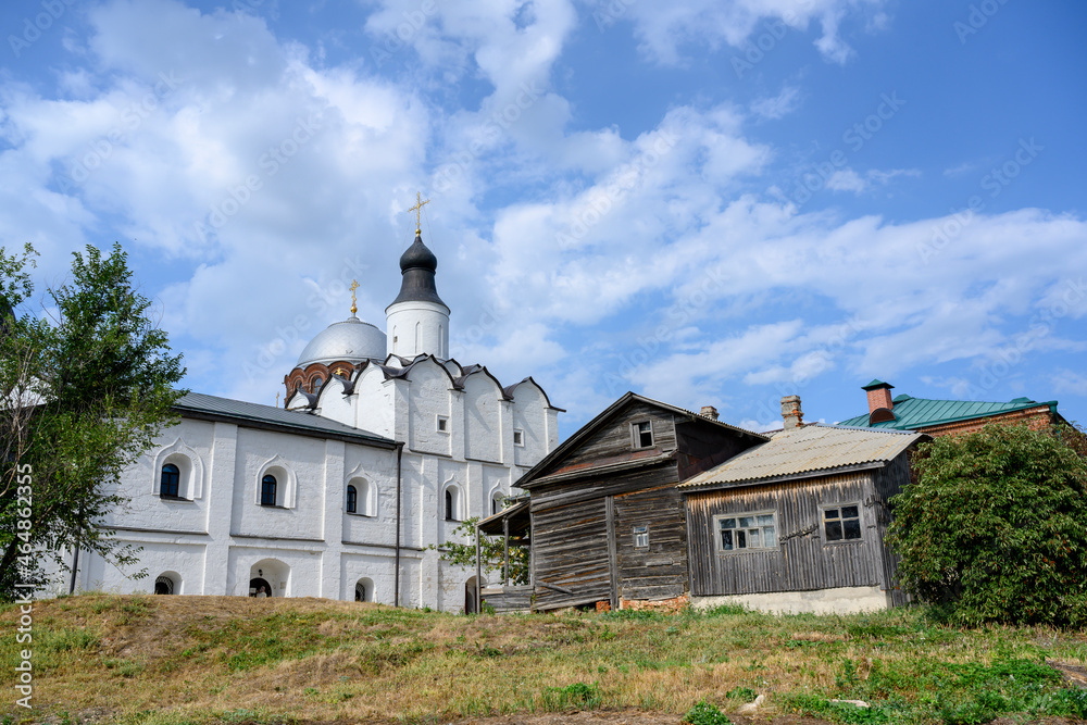 St. Sergius Church and an old wooden building on the territory of the St. John the Baptist Monastery in Sviyazhsk, Russia St. Sergius Church and an old wooden building on the territory of the St. John the Baptist Monastery in Sviyazhsk, Russia