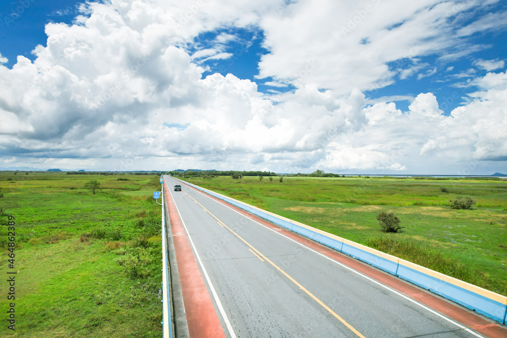 road in the countryside view of the sea and mountains