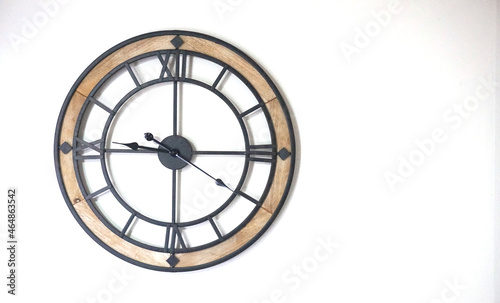 Modern metal and wood wall watch on white background