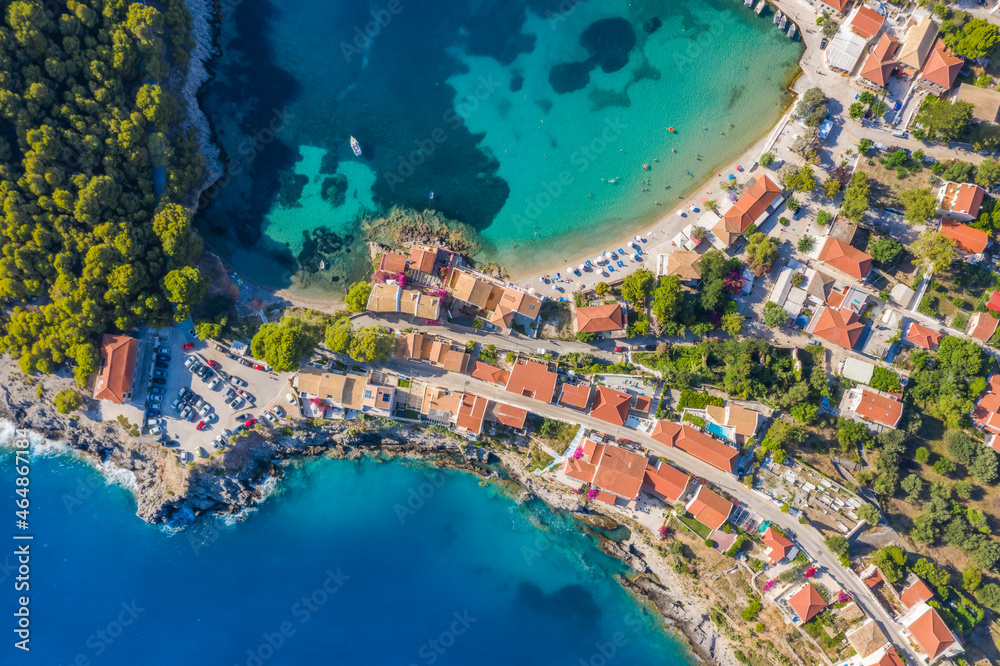 Assos picturesque fishing village from above, Kefalonia, Greece. Aerial drone view. Sailing boats moored in turquoise bay