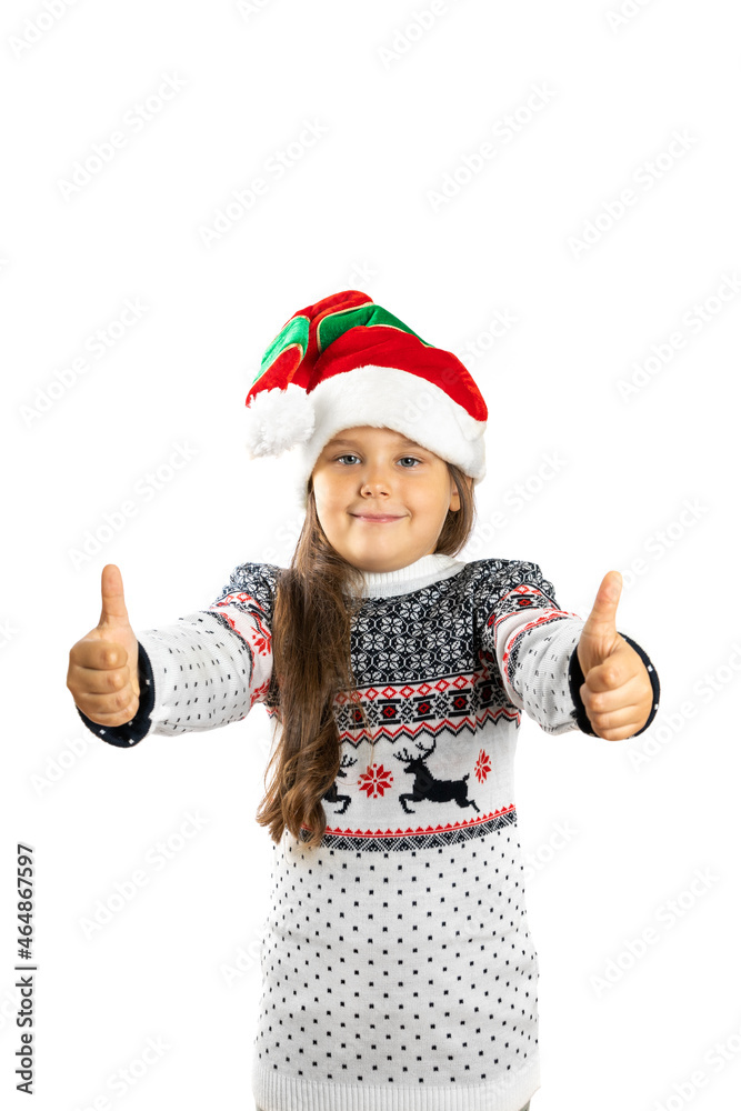 portrait of sweet, kind girl in white knitted Christmas sweater with reindeer and dwarf hat giving thumbs up, isolated on white background. portrait of sweet, kind girl in white knitted Christmas sweater with reindeer and dwarf hat giving thumbs up, isolated on white background.