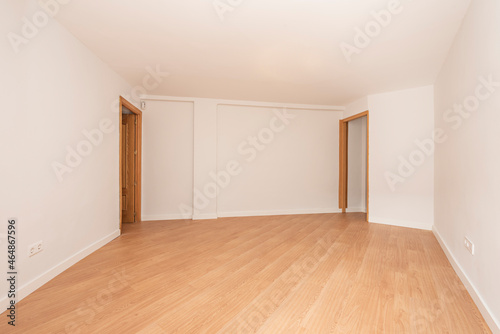 white painted room with oak flooring and oak doors and frames