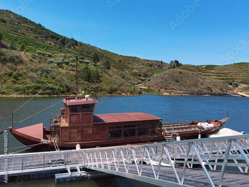 Wooden boat moored at the pier of the river Tua photo