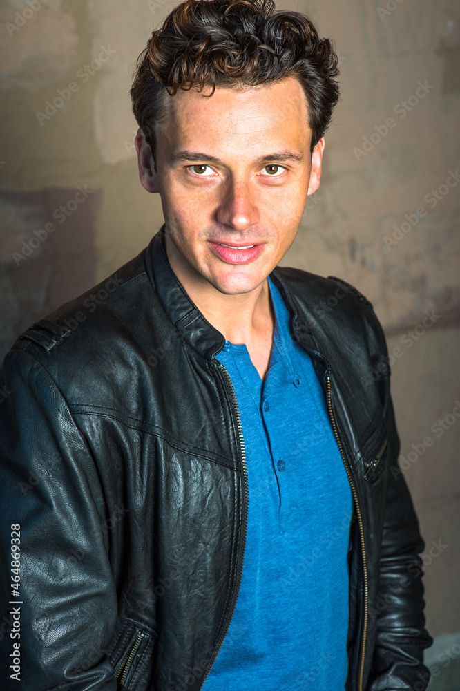 Dressing in a black leather jacket, a blue shirt, a young handsome guy is charmingly looking at you. Dressing in a black leather jacket, a blue shirt, a young handsome guy is charmingly looking at you.