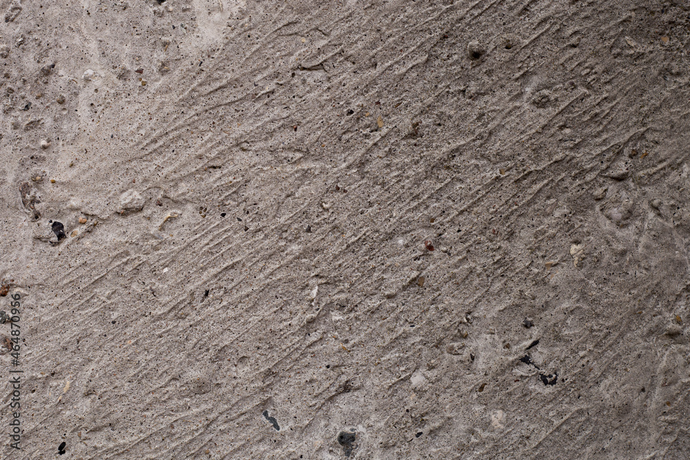 Obraz premium The abstract background is the texture of a concrete gray wall.