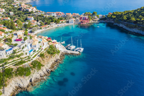 Fototapeta Naklejka Na Ścianę i Meble -  Assos picturesque fishing village from above, Kefalonia, Greece. Aerial drone view. Sailing boats moored in turquoise bay